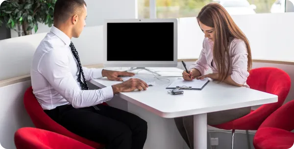 Business meeting for UAE outpass cancellation process in a modern office setting.