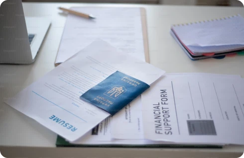 Essential paperwork for visa cancellation process in UAE displayed on a desk.