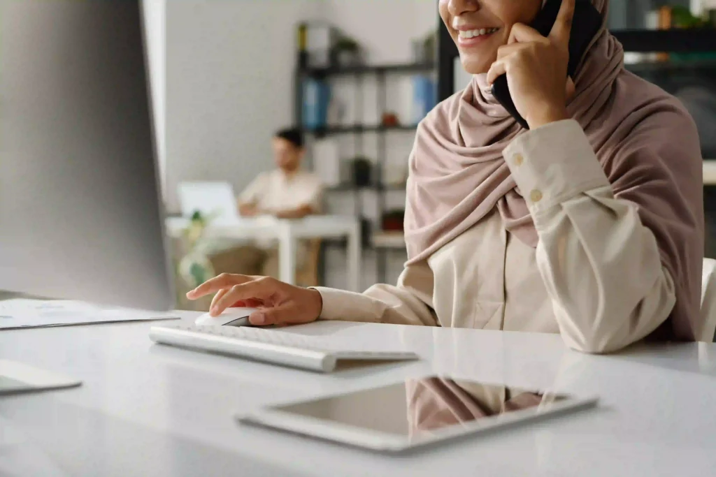 Emirati woman assisting with document clearing services in a Dubai office