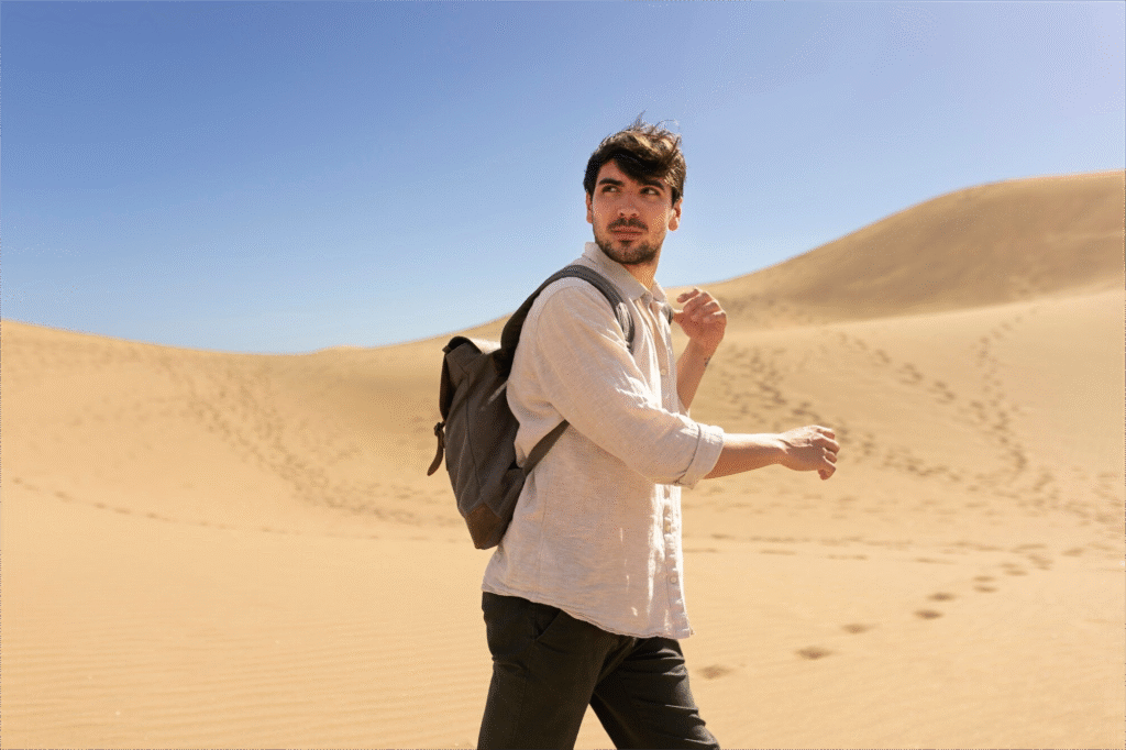Man hiking in UAE desert, representing challenges of absconding in UAE.