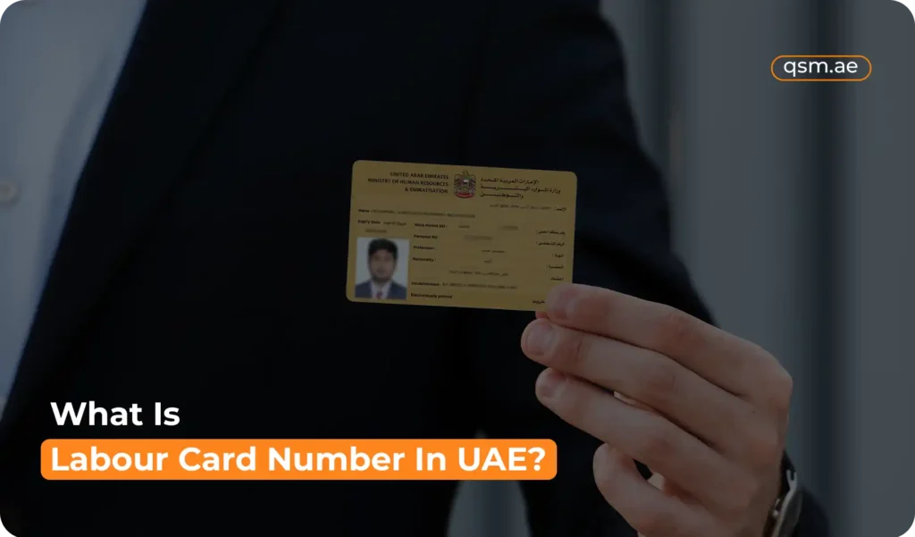 Person holding UAE labour card explaining what is Labour Card Number in UAE for work identification.